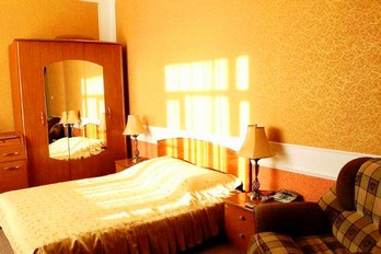 Кровать в номере люкс в первом корпусе санатория Здоровье в городе-курорта Железноводск